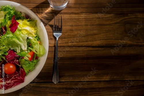 Healthy bowl of salad on wooden table
