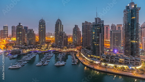 Luxury yacht bay in the city aerial night to day timelapse in Dubai marina