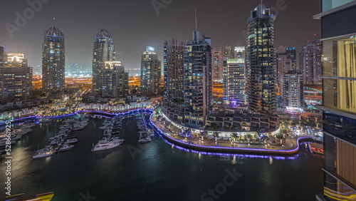 Panorama showing luxury yacht bay in the city aerial night timelapse in Dubai marina © neiezhmakov