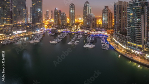 Luxury yacht bay in the city aerial night to day timelapse in Dubai marina