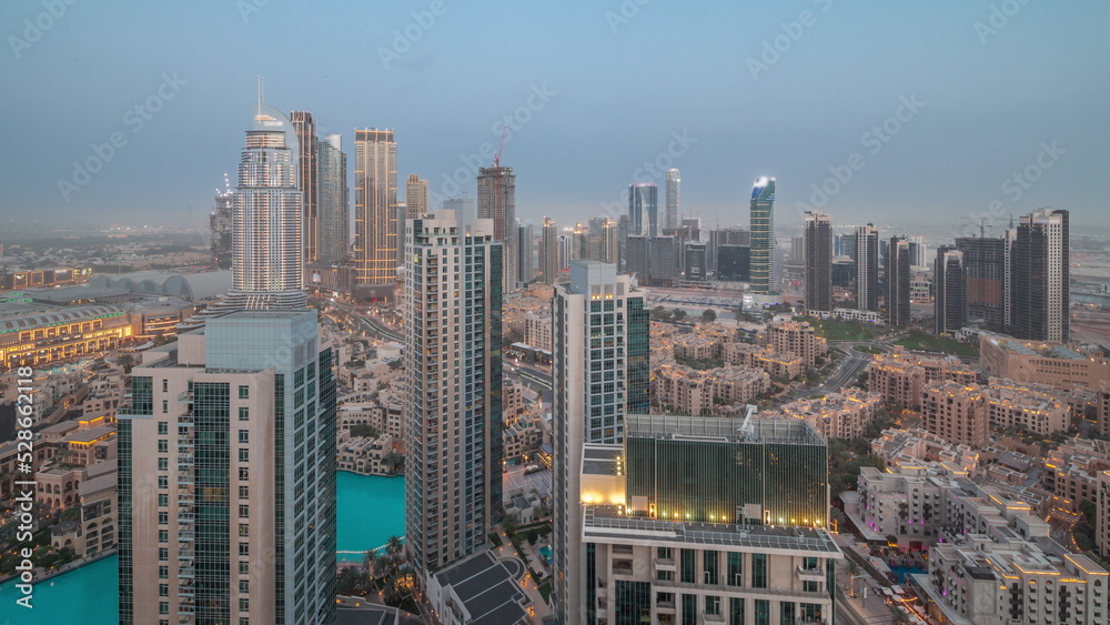 Fototapeta premium Aerial view of a big futuristic city day to night timelapse. Business bay and Downtown