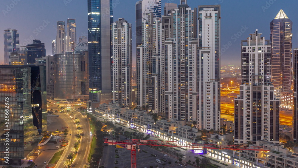 Bay Avenue with modern towers residential development in Business Bay aerial night to day timelapse, Dubai