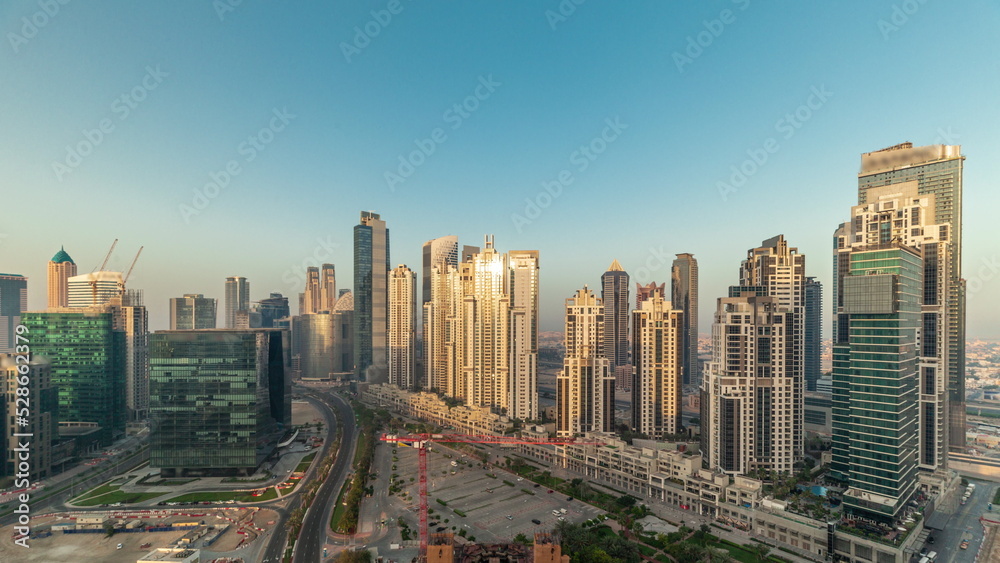Bay Avenue during sunrise with modern towers in Business Bay aerial panoramic timelapse, Dubai