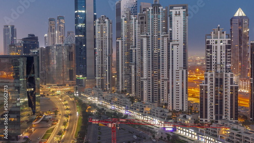 Bay Avenue with modern towers residential development in Business Bay aerial night to day timelapse  Dubai
