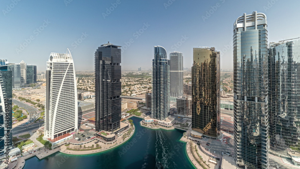 Fototapeta premium Panorama showing tall residential buildings at JLT aerial timelapse, part of the Dubai multi commodities centre mixed-use district.