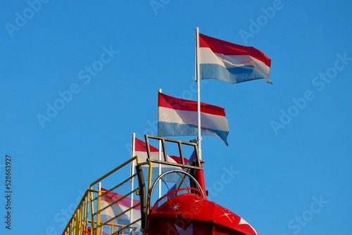 Many Luxembourg flags flying free in Schueberfouer fun fair in Luxebourg city