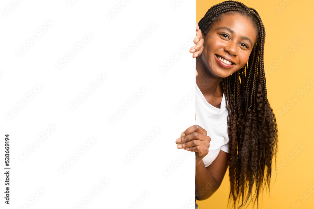 Advertising concept. Smiling attractive black woman peeking out from
