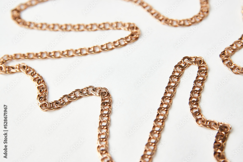 Gold chain on a white background with copy space Gold chain on a white background with copy space