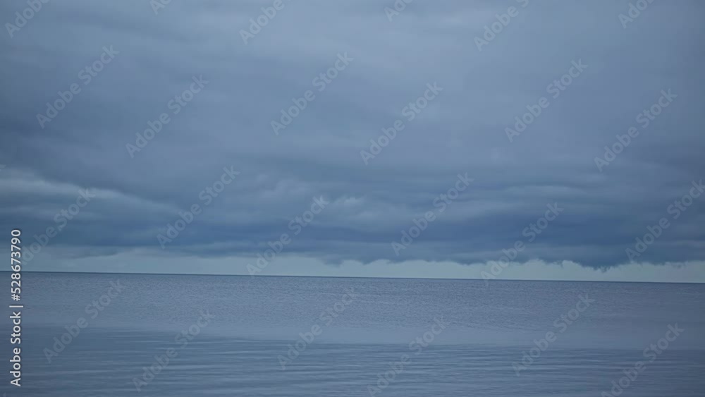 Timelapse shot of movement of thick clouds over blue sea water along shoreline at daytime. Timelapse shot of movement of thick clouds over blue sea water along shoreline at daytime.