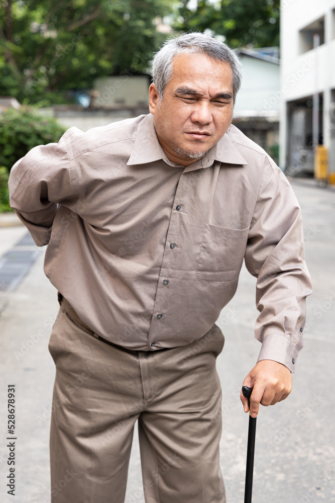 Overweighted, obese senior old man suffering from herniated disc or