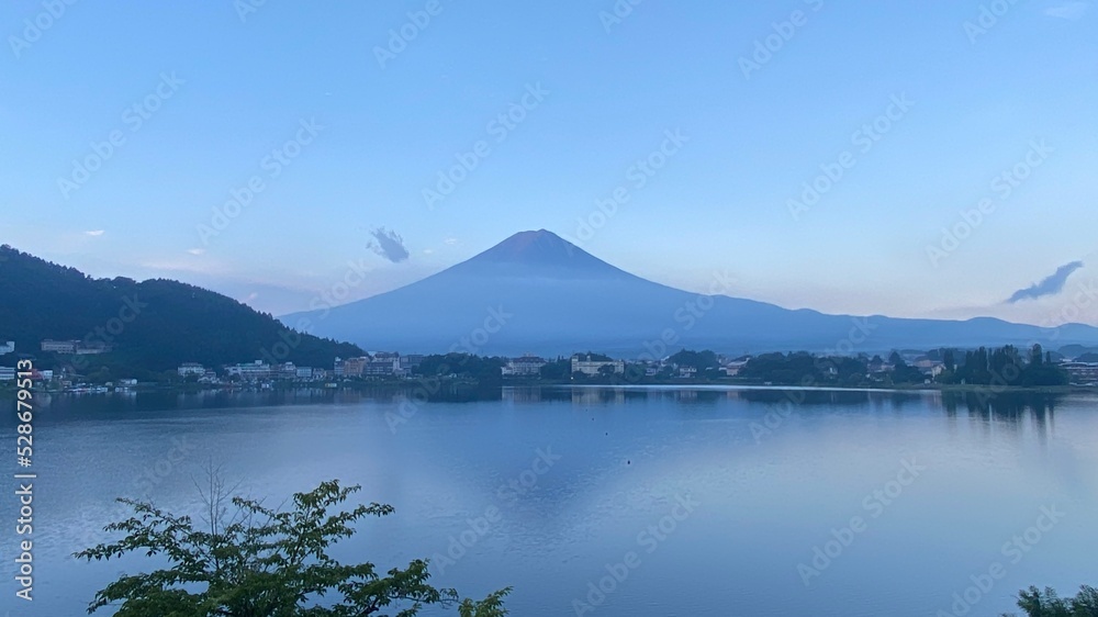 Magnificent Japanese traditional view, Mt Fuji at just after 5:30 am, the beautiful mountain silhouette revealed in whole after cloudy evening the day before.  Photo taken year 2022 August 27th