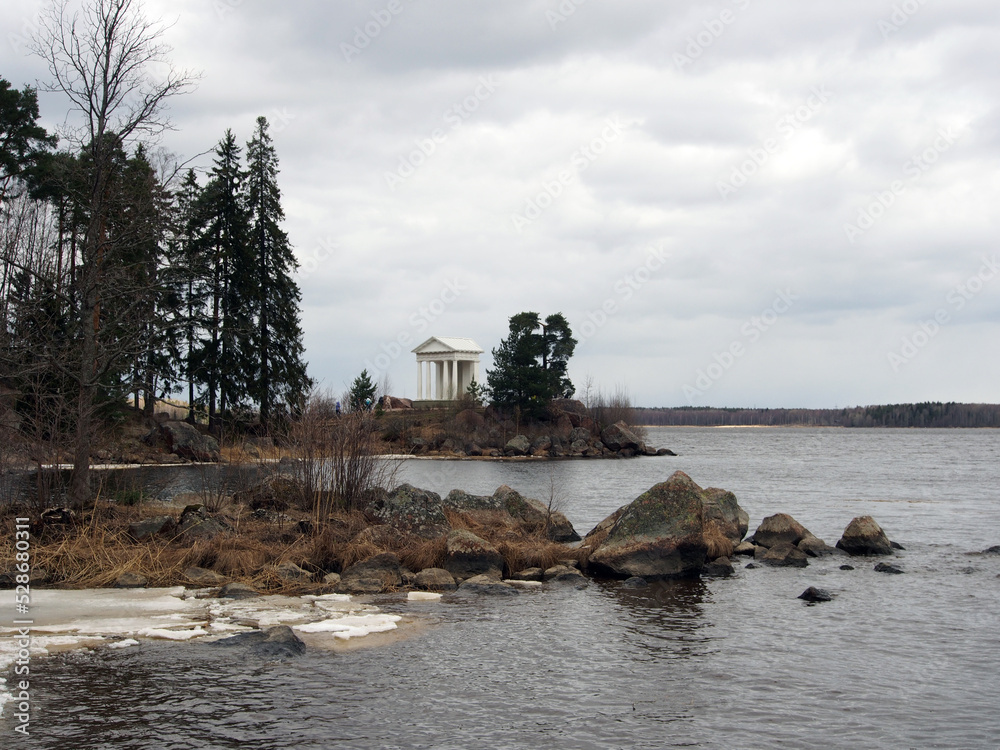 Northern landscape, rocky shores with sparse vegetation against the background of the sea with remnants of ice. Landscape photography, variety of landscapes, travel. Northern landscape, rocky shores with sparse vegetation against the background of the sea with remnants of ice. Landscape photography, variety of landscapes, travel.