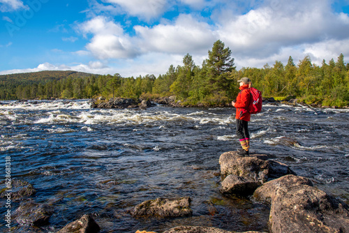 Woman hiking in forest in Finland Lapland