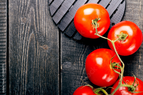Tomatoes on a wooden background, in rustic style. Food background in flat lay style