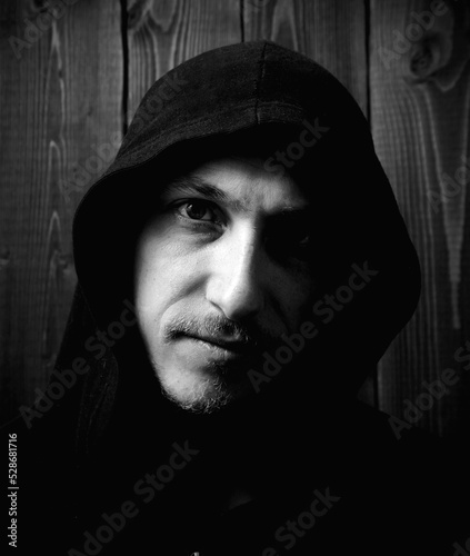 Portrait of a man in a hood, black and white photo