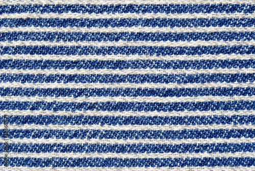 Striped in white and blue colors cotton fabric texture as background