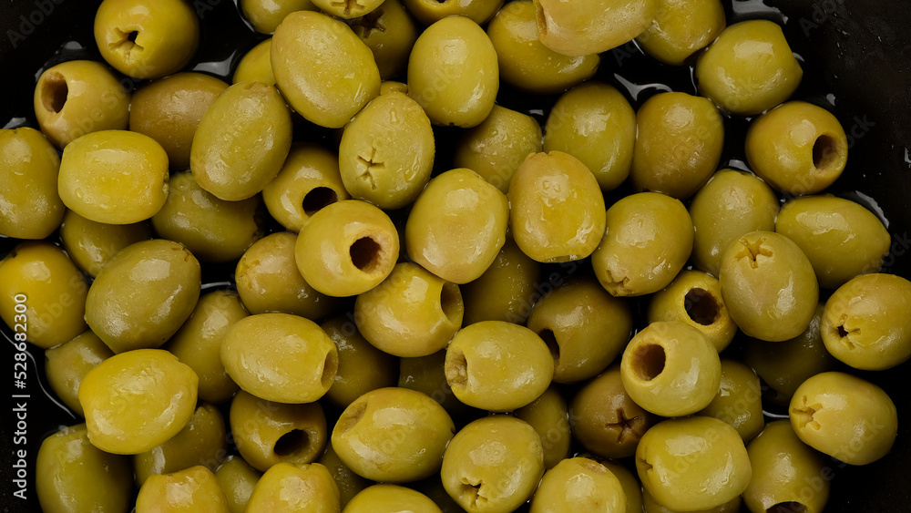 Green olives close up, rotate. Pitted olives Green olives close up, rotate. Pitted olives