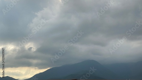 Airy sky with smooth clouds and the mountain silhouette from the highway to Yamanashi prefecture from Tokyo, year 2022 August 26th, Japan