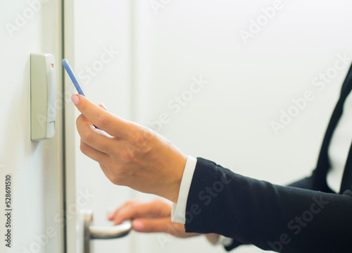 businesswoman hand with magnetic electronic key