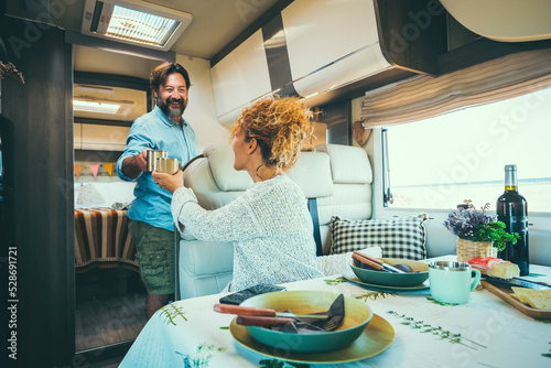 Obraz na płótnie Couple living off grid inside a modern luxury camper van and enjoy travel lifestyle