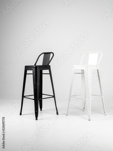 White and black bar chairs on white background
