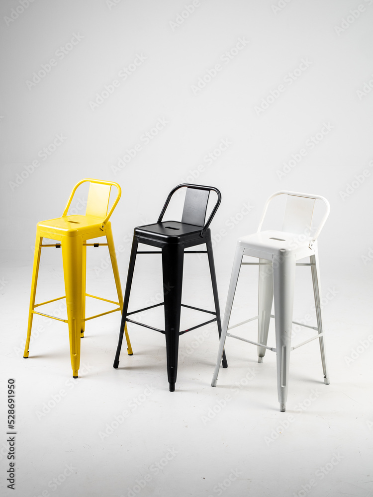 White, black and yellow bar chairs on white background