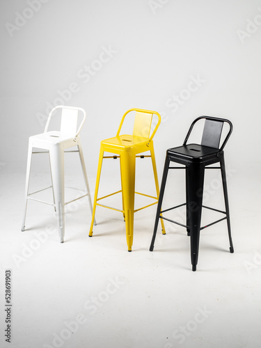 White, black and yellow bar chairs on white background