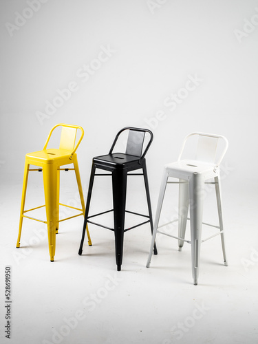 Obraz na płótnie White, black and yellow bar chairs on white background w salonie