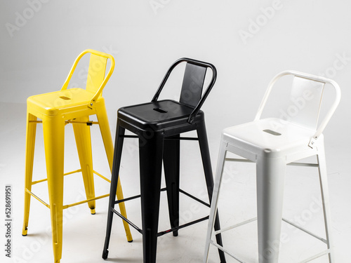 White, black and yellow bar chairs on white background photo