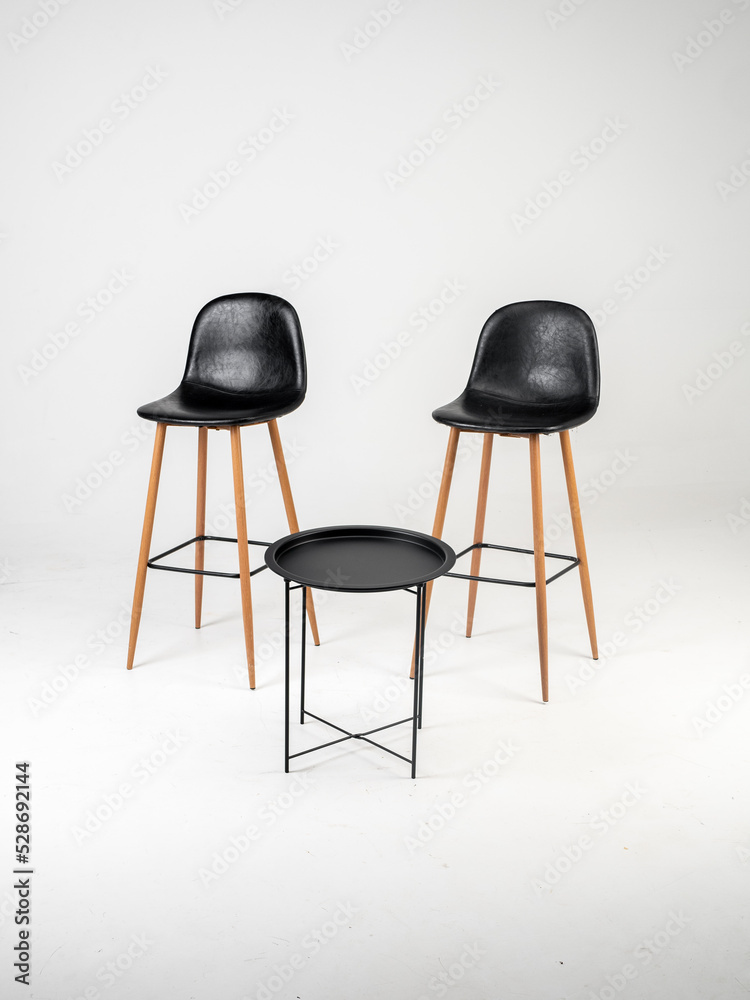 Black bar skin chairs with wood chair leg and black table on white background