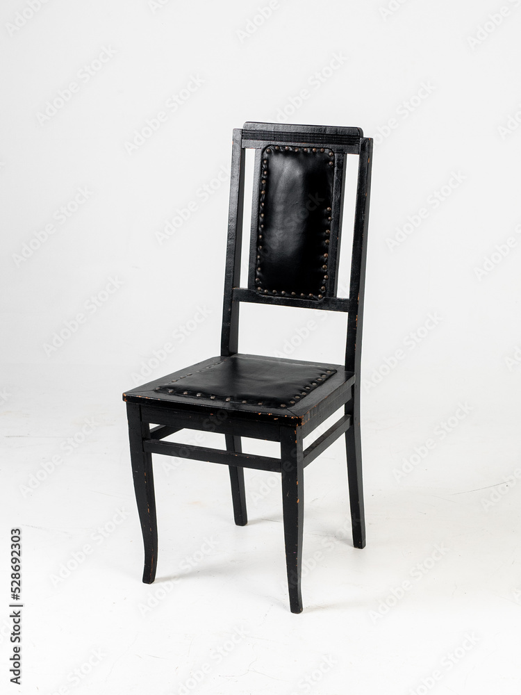 Old black skin chair on white background