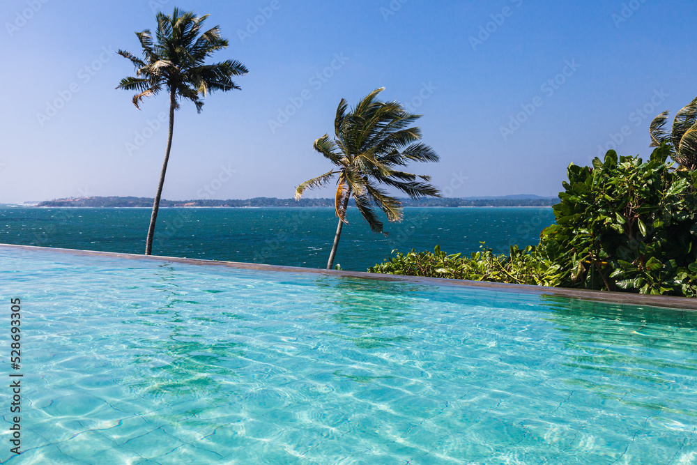 Beautiful turquoise pool overlooking the endless blue ocean