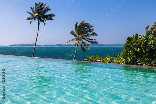 Beautiful turquoise pool overlooking the endless blue ocean