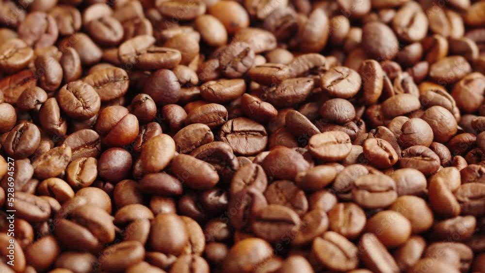 Roasting coffee beans with smoke on dark background, close up arabica robusta colombian beans. Roasting coffee beans with smoke on dark background, close up arabica robusta colombian beans.
