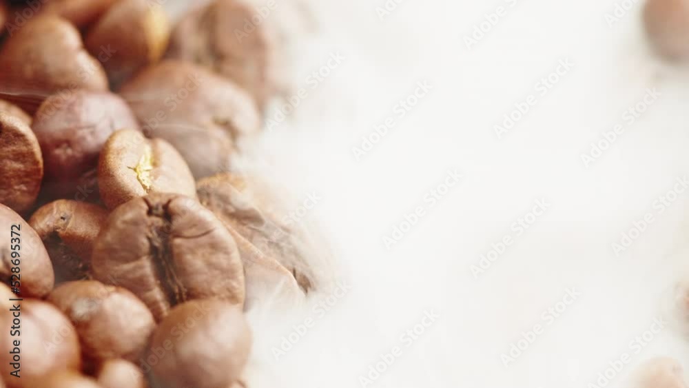 Roasting coffee beans with smoke on dark background, close up arabica robusta colombian beans. Roasting coffee beans with smoke on dark background, close up arabica robusta colombian beans.