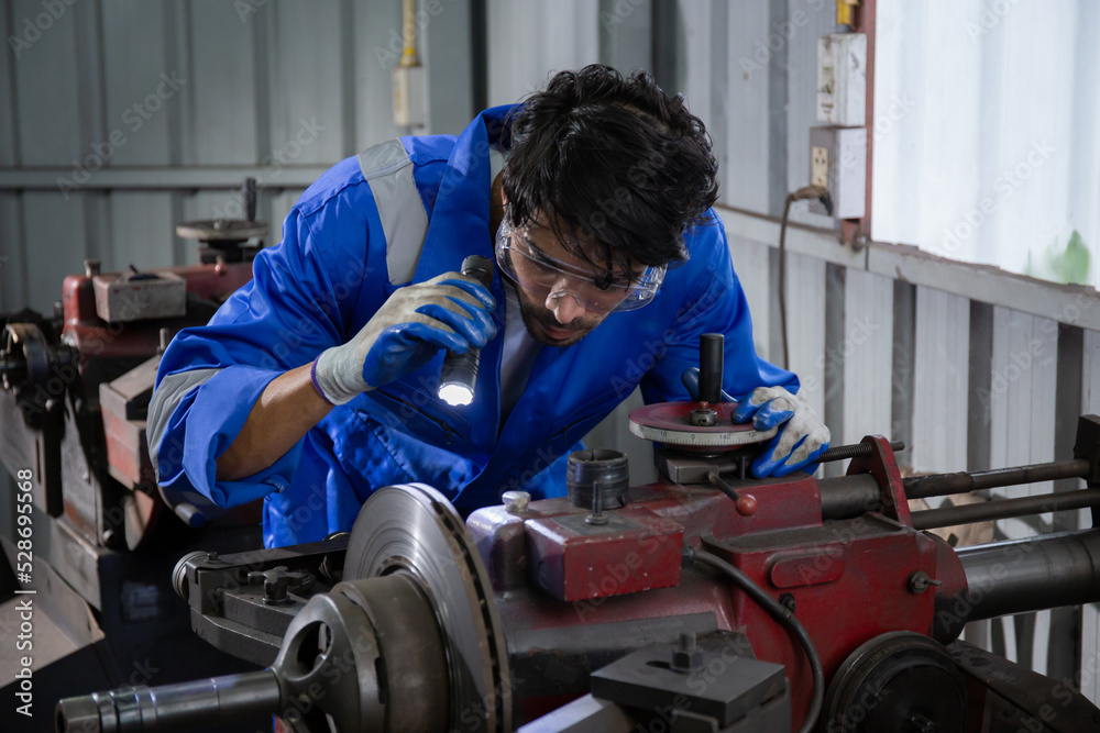 Young man sanding or iron at industrial factory, mechanic working job while polish metal, male having skill built steel with tool, engineer and equipment, labor and steelworks, industry concept. Young man sanding or iron at industrial factory, mechanic working job while polish metal, male having skill built steel with tool, engineer and equipment, labor and steelworks, industry concept.