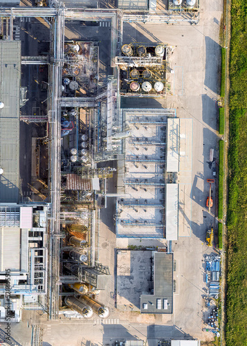 Bird's eye shot with drone, FIS chemical plant Gambellara (VI) Italy, September 05 2022 in the late afternoon. We see the production plants, liquid transport system and storage pipes, evaporative towe © Stefano
