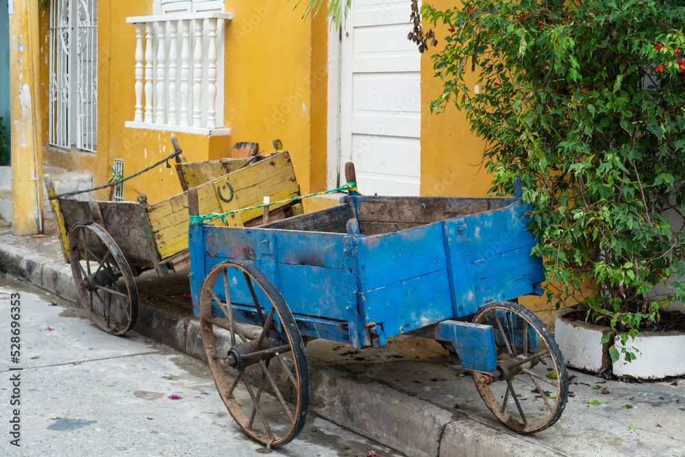 Colorful carriages for the transport of goods, yellow and blue on the street