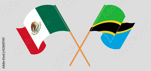 Crossed and waving flags of Mexico and Tanzania