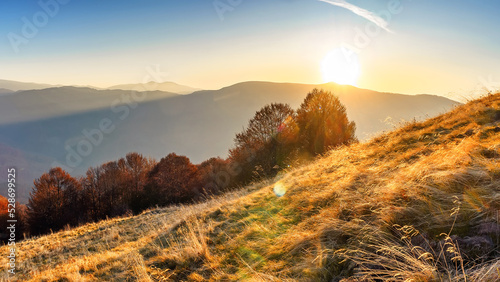 Fototapeta Naklejka Na Ścianę i Meble -  dawn among mountain dry grasses. Panorama of the autumn morning landscape. Autumn in the Ukrainian Carpathians