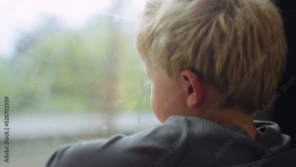 Young Boy Looking Out Of Train Window At The Passing Countryside Young Boy Looking Out Of Train Window At The Passing Countryside