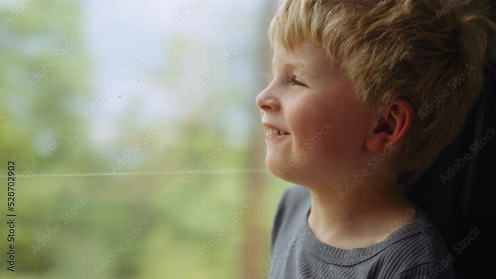 Young Boy Looking Out Of Train Window At The Passing Countryside Young Boy Looking Out Of Train Window At The Passing Countryside