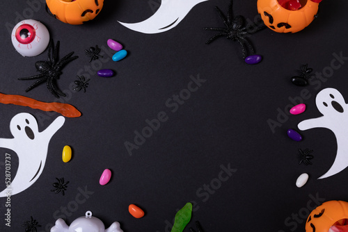 Halloween candies and toys with copy space on grey background