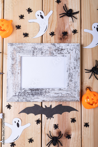 Frame with copy space and multiple halloween toys on wooden surface
