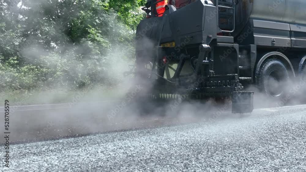 Heavy Machinery Resurfacing a Road Using Micro Asphalt Dressing Heavy Machinery Resurfacing a Road Using Micro Asphalt Dressing