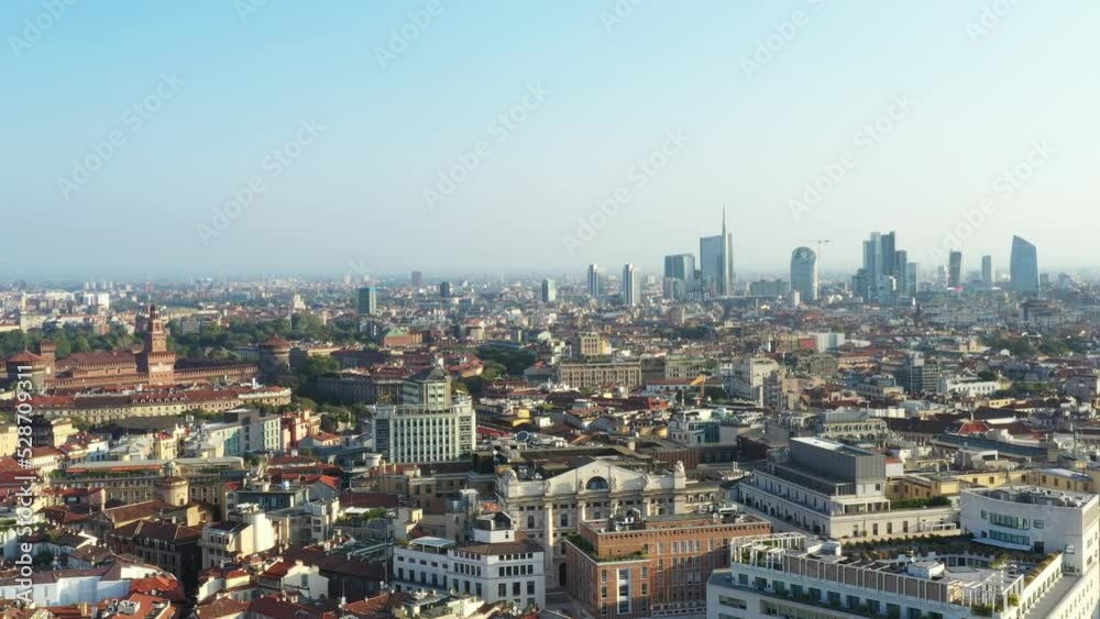 Milano from the drone in a sunny morning. Ascending flight with historic Sforzesco castle view and Porta Nuova skyscrapers district on the background. Milano from the drone in a sunny morning. Ascending flight with historic Sforzesco castle view and Porta Nuova skyscrapers district on the background.
