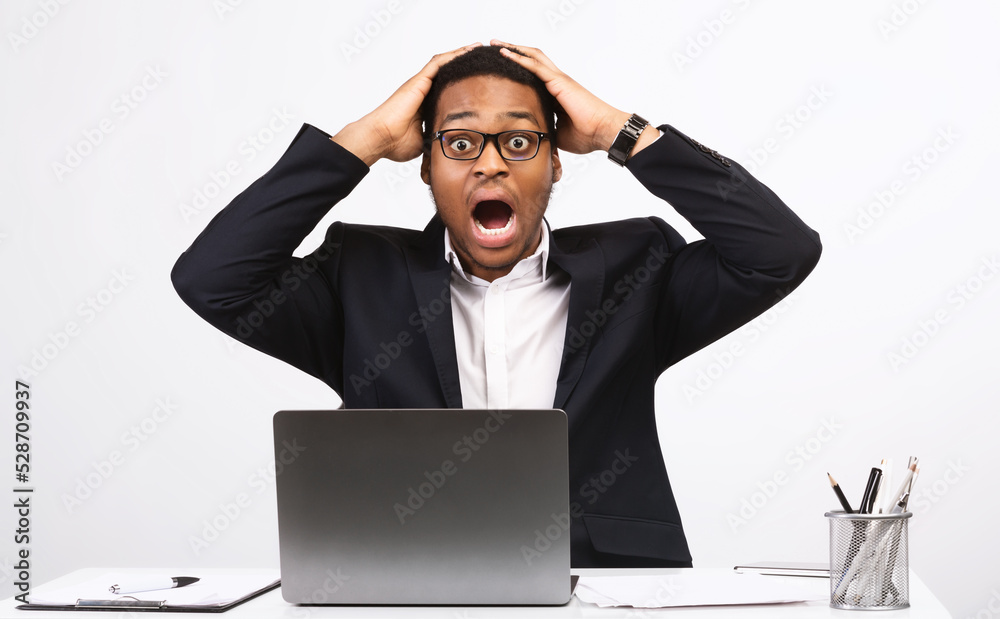 Shocked African Businessman At Laptop Shouting Having Problem, White Background Shocked African Businessman At Laptop Shouting Having Problem, White Background