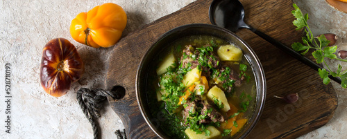 a bowl of stewed potatoes with venison on the table