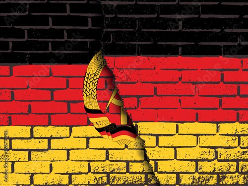a destroyed brick wall with the flag of Germany on top of the flag of the GDR