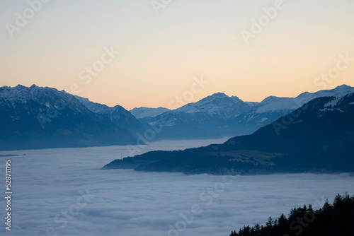 sunset behind the mountains, mountains floating on fog